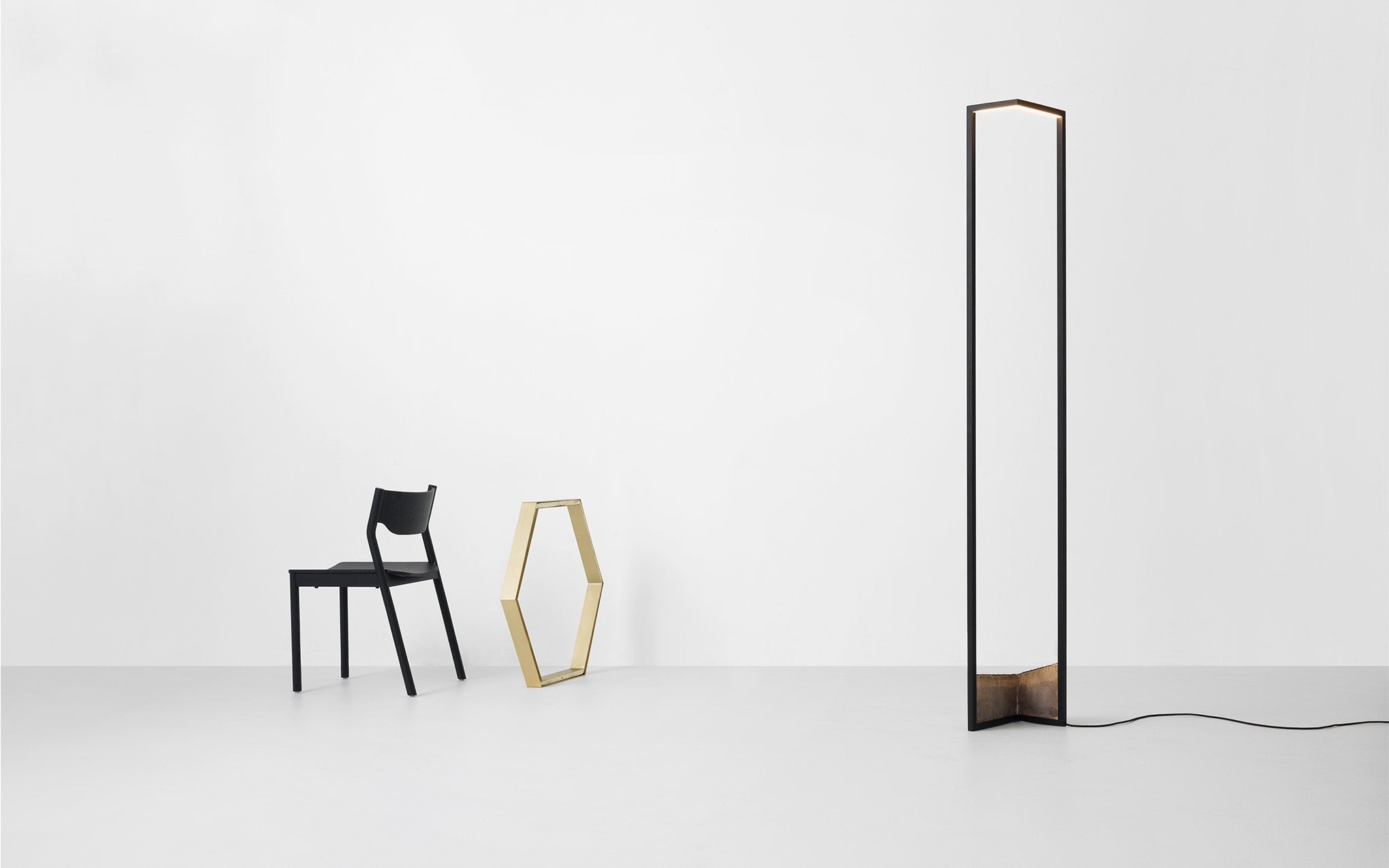 A graphic floor lamp with a bronze base.