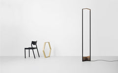 A graphic floor lamp with a bronze base.