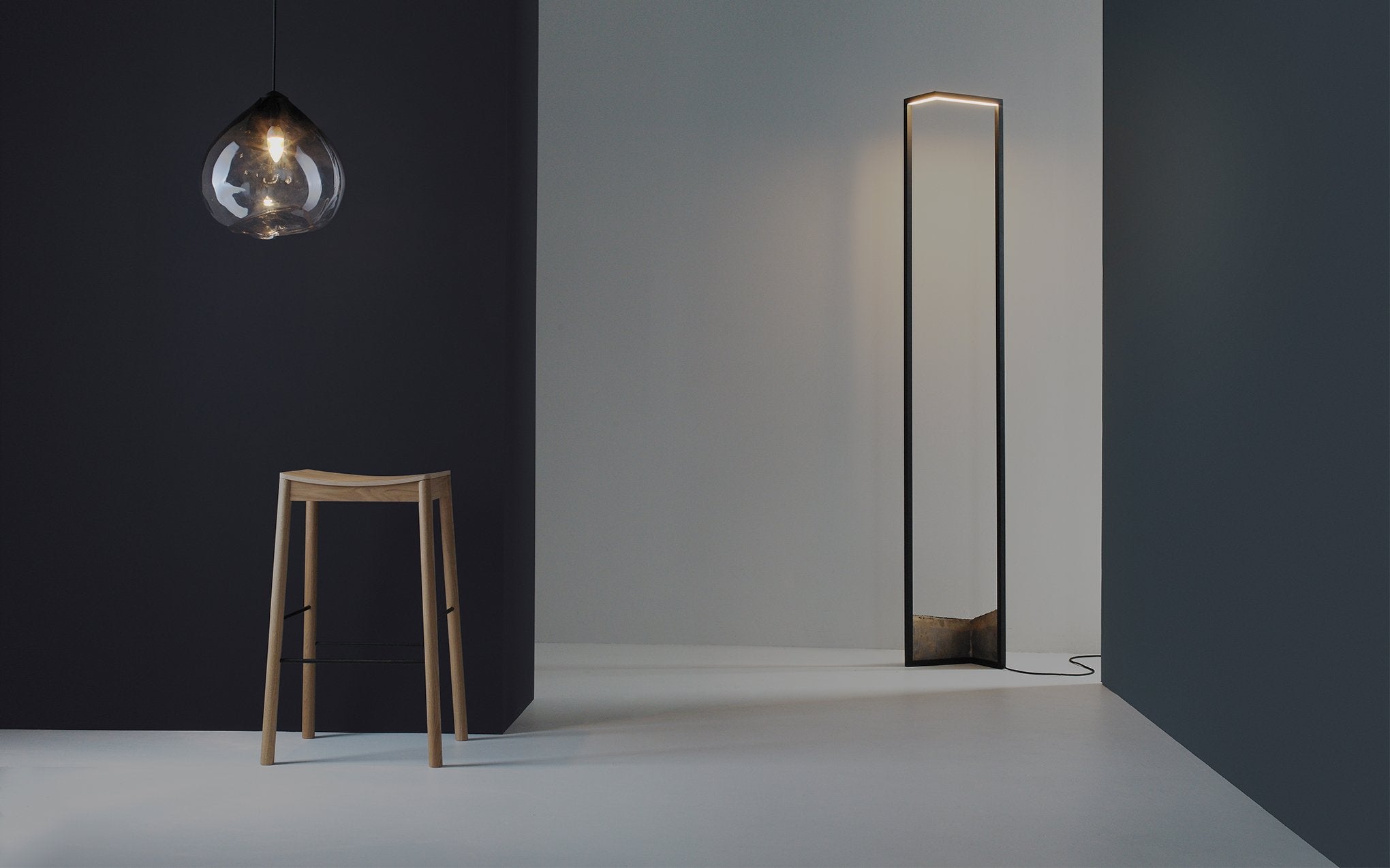 A graphic floor lamp with a bronze base.