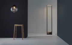 A graphic floor lamp with a bronze base