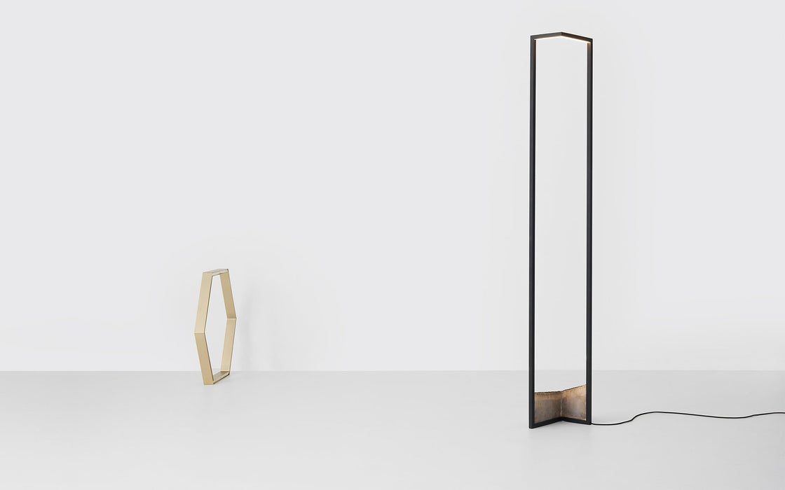 A graphic floor lamp with a bronze base.